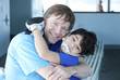 Disabled boy giving father a big hug