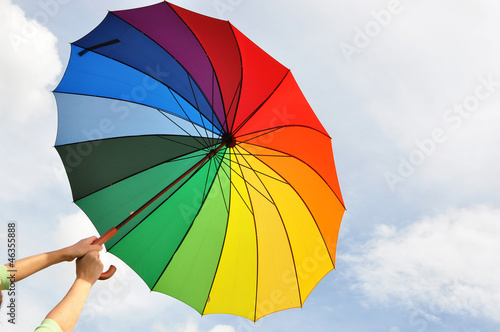 Photo: Rainbow umbrella in the hands Rainbow umbrella in the hands