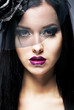 Photo: Close-up portrait of a young sad woman with black mourning veil Close-up portrait of a young sad woman with black mourning veil