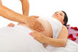 Therapist massaging pregnant belly