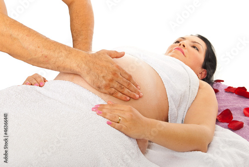 Photo: Therapist massaging pregnant belly Therapist massaging pregnant belly