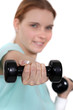 A woman lifting weights.