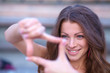 young beautiful woman making frame with her hands