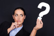 Businesswoman holding a question mark