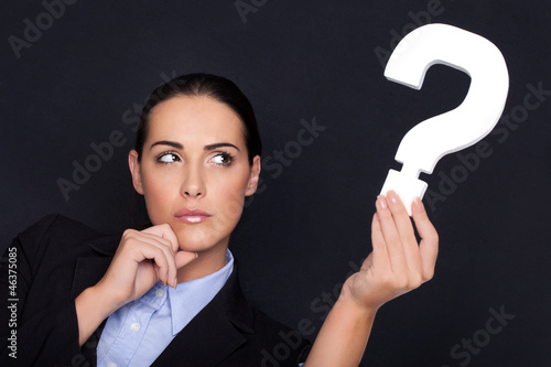 Photo: Businesswoman holding a question mark Businesswoman holding a question mark