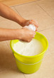 Hands wringing the water out of a mop cloth