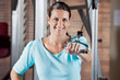 Happy Woman Working Out In Health Club
