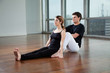 Yoga Instructor Helping Woman With A Pose