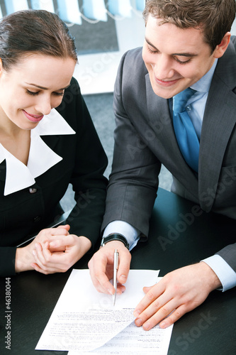 Photo: Businesspeople with documents at office Businesspeople with documents at office