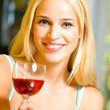 Young woman with glass of red wine