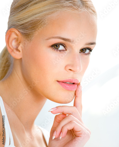 Photo: Beautiful blond woman with finger on lips Beautiful blond woman with finger on lips