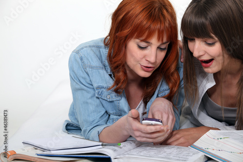 Photo: Students taking a break from their studies to read a message Students taking a break from their studies to read a message