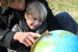 Father and son looking at a globe