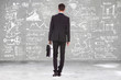 business man with briefcase looking at calculations