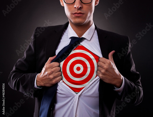 Photo: business man showing a target under his shirt business man showing a target under his shirt