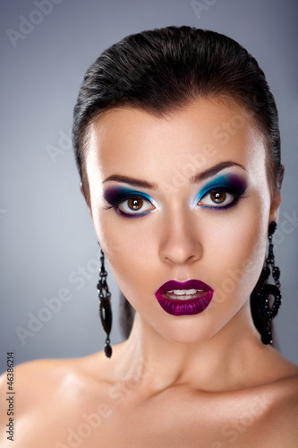 Photo: Holiday evening make up. Stylish beauty young woman face Holiday evening make up. Stylish beauty young woman face