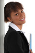 Businesswoman leaning against a wall