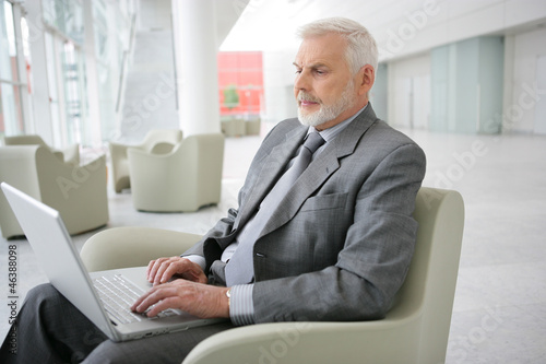 Photo: Senior businessman waiting in airport Senior businessman waiting in airport