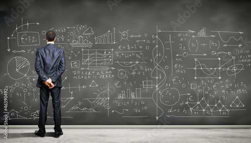 Photo: Business person against the blackboard Business person against the blackboard