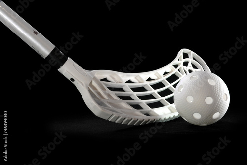 Photo: A silver floorball stick and white ball A silver floorball stick and white ball
