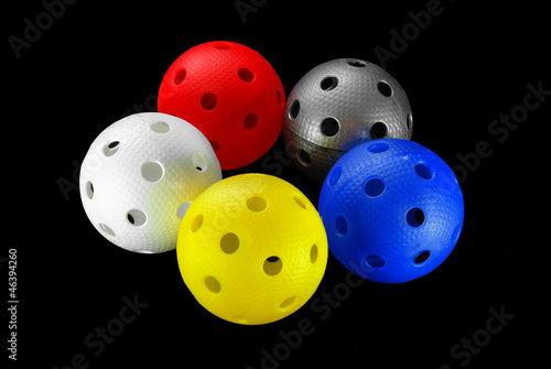 Photo: Five floorball balls isolated on a black background Five floorball balls isolated on a black background