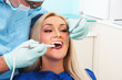 Dentist examines teeth of the patient with teeth-camera