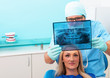 Dentist shows a patient x-ray