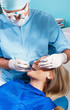 Photo of a dentist curing a girls teeth