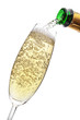 Photo: Champagne pouring into a glass. Champagne pouring into a glass.