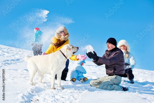 Photo: Kids and parents throwing snow Kids and parents throwing snow