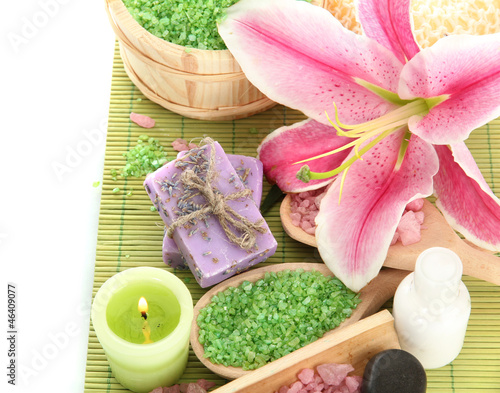 Photo: beautiful spa setting with lily isolated on white beautiful spa setting with lily isolated on white