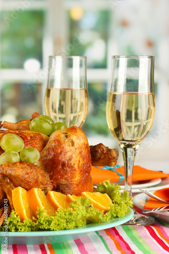Photo: banquet table with roast chicken and glasses of wine. banquet table with roast chicken and glasses of wine.