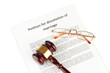 Divorce decree and wooden gavel on white background