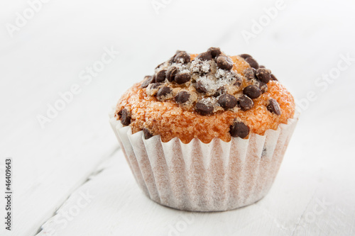 Photo: Chocolate chip muffin on white wood Chocolate chip muffin on white wood