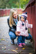 Infant baby girl in golden autumn park