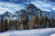 Rocky mountain peaks under clouds in a blue sky
