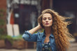 Foto: Beautiful young Caucasian girl with curly hair outdoors Beautiful young Caucasian girl with curly hair outdoors