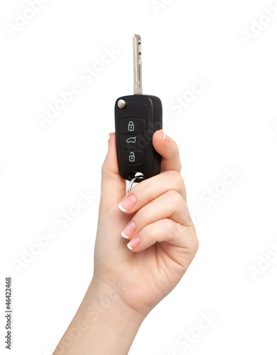 Photo: woman hand on isolated background holding car key woman hand on isolated background holding car key