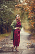 Style redhead girl at beautiful autumn alley.