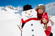 Winter fun, snowman and happy family