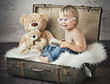 A funny picture of little boy in suitcase