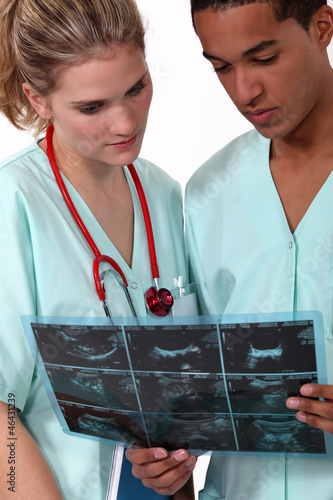 Photo: Two doctors examining x-ray image Two doctors examining x-ray image