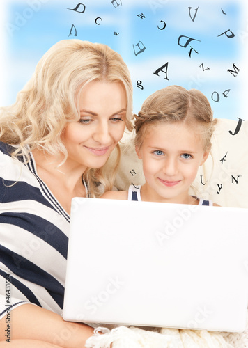 Photo: happy mother and child with laptop computer happy mother and child with laptop computer