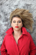 Woman in red lying with her hair spread on a rug