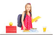 A schoolgirl with bag and book preparing for lunch