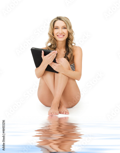 Photo: woman in bikini with tablet pc computer woman in bikini with tablet pc computer