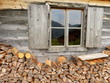 Brennholz an der Almhütte mit Fenster