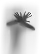 Hands, fingers behind a diffuse glass surface