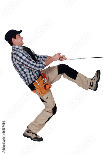 Photo: Handyman pulling a rope Handyman pulling a rope