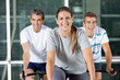 Men And Woman On Exercise Bikes